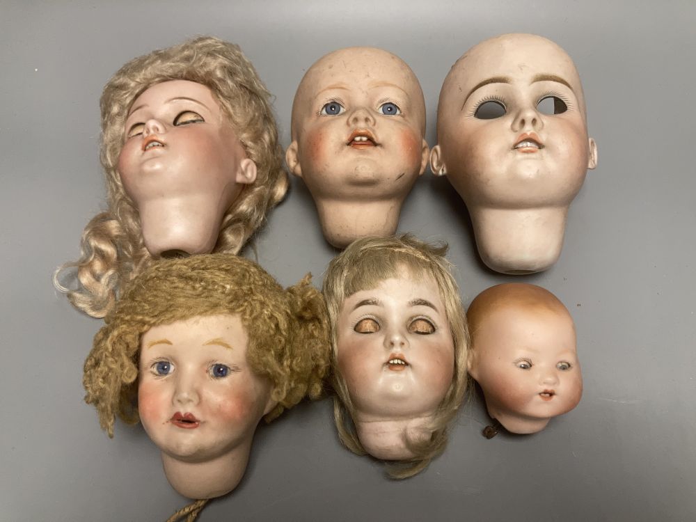 A Kammer & Reinhardt / Simon & Halbig bisque doll head, 10cm, three other German bisque doll heads and two English bisque doll heads,